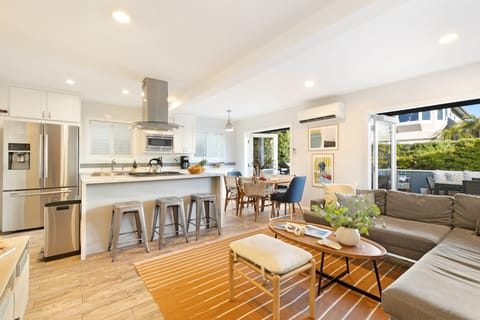 Open-concept living room, kitchen, and dining area.