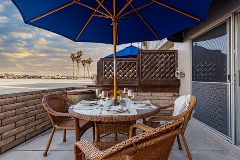 Step onto the sand from your bayfront patio.