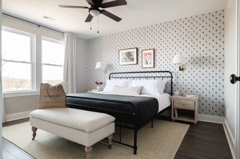 Primary bedroom features a king bed and a TV.