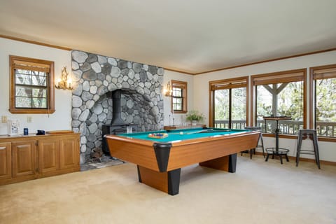 Fireplace and pool table in the game room.