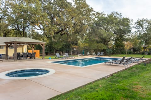 Beautiful backyard with a pool and hot tub.