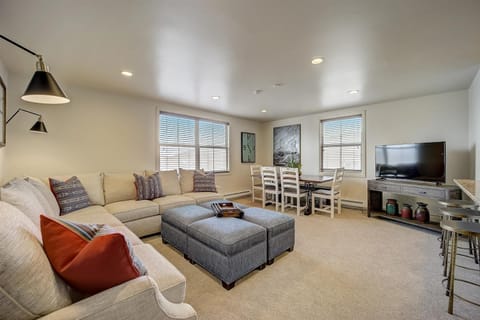 Wonderful living area with eight person couch and eight person dining table.