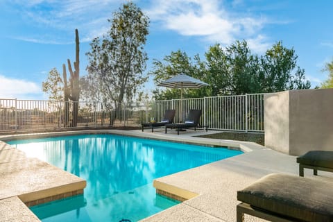 Lounge by the pool in the desert sun.