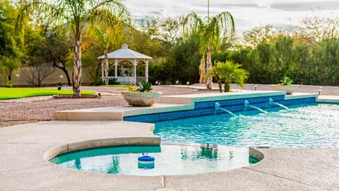 Pool and hot tub in the spacious backyard.