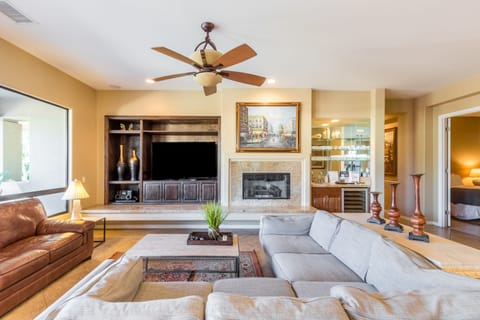 Beautiful interior design with a fireplace, TV, and large sectional in the living room.