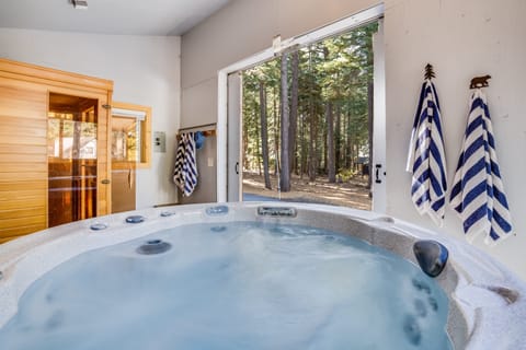 Hot tub and sauna in detached spa.