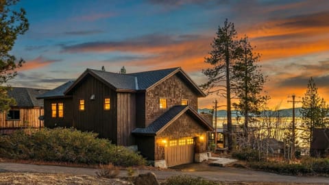 Sunlit great room with a stone fireplace, cozy seating, and direct access to the patio—perfect for laid-back nights in.