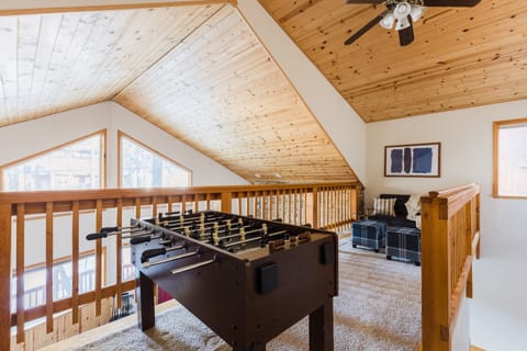 Both cabins feature an upstairs loft with foosball and a seating area.