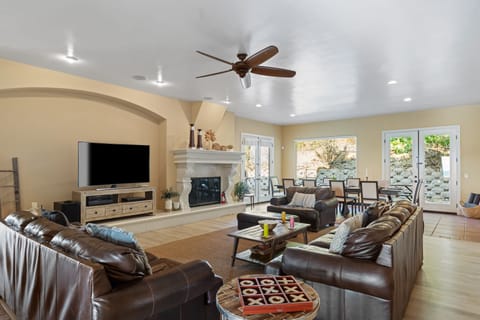 Spacious living room with fireplace and flat-screen television.