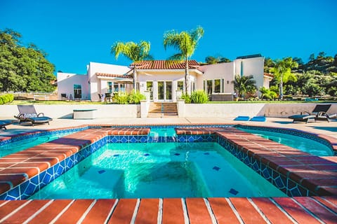 Gorgeous terra cotta style tiling surrounding pool.