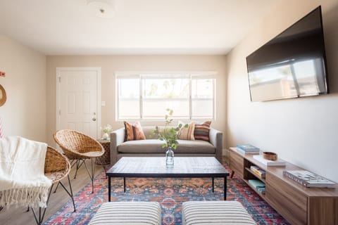 Living area features a TV, comfy seating, and a sleeper sofa.