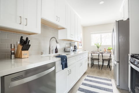 Bright kitchen features modern appliances.