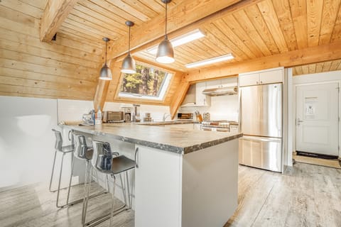 Spacious kitchen features modern appliances and a breakfast bar.