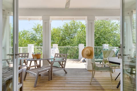 Second-level balcony with loungers and seating.