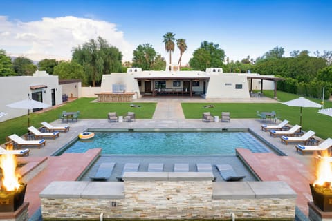 Massive backyard with a pool, hot tub, and entertainment area.