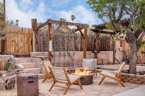 Stunning backyard with an electric firepit and desert landscaping.