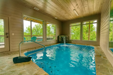 Unique indoor pool area with a waterfall.