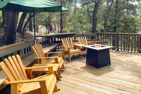 Spacious deck with comfortable seating and a firepit.