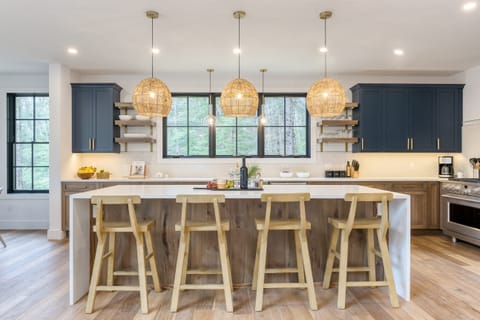 Spacious kitchen features a large island with barstool seating.