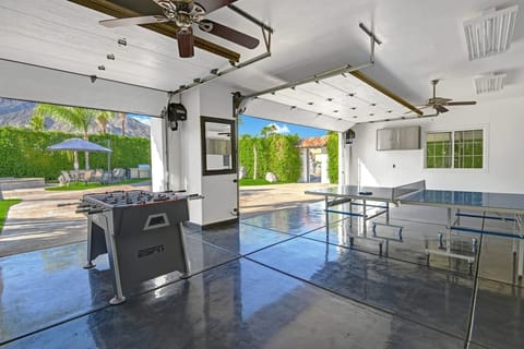 Garage game room features ping pong and foosball.