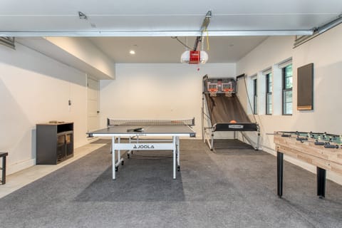 Recreation room with multiple games, including foosball and ping pong.