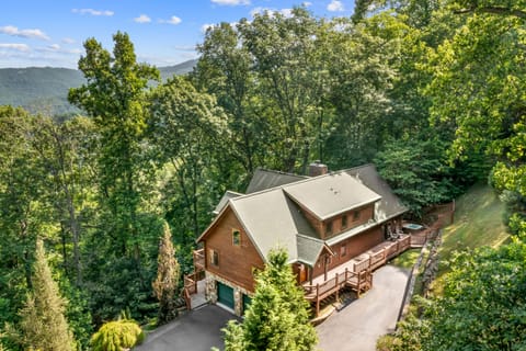 Stunning great room with vaulted ceilings, a fireplace, and floor-to-ceiling windows with mountain views.