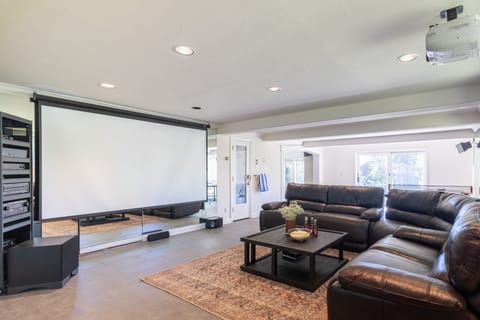 Recreation room with games and a projector screen.