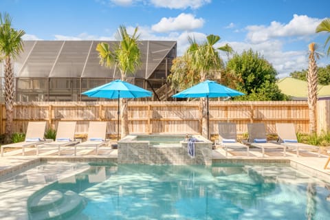 Your private pool and hot tub are surrounded by loungers.