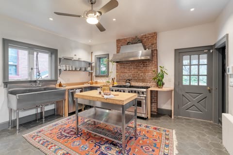 Industrial-style kitchen with an oversized range and sink.