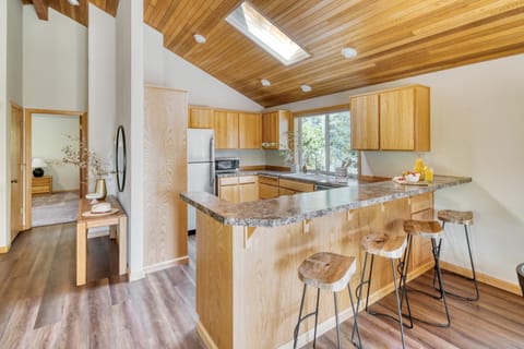 Bright kitchen features barstool seating.