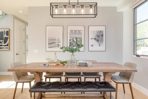 Chic dining area features a mix of traditional and bench seating.