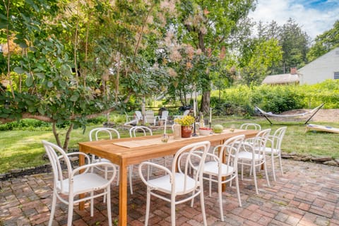 A pictureque outdoor dining table on the patio makes al fresco meals a breeze.