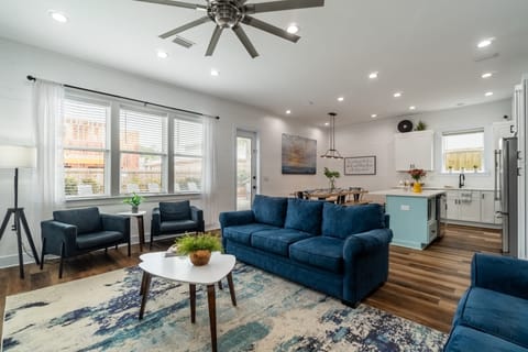 Open common area with a living space, dining table, and kitchen.