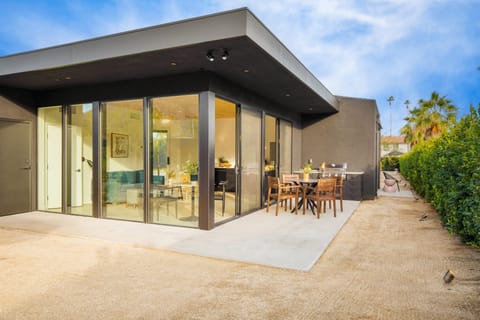 The C Suite features a spacious patio with an outdoor dining table and BBQ grill.