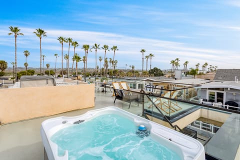 Rooftop includes a hot tub, lounge, and outdoor dining area.