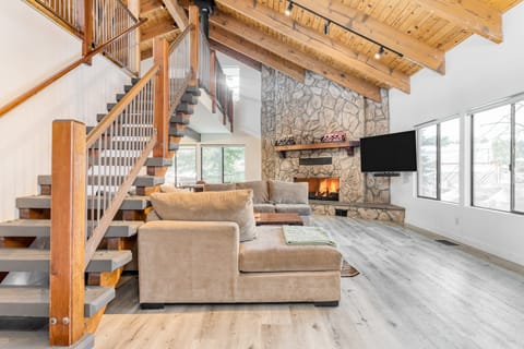 Vaulted ceilings, open design, and a living room fireplace.