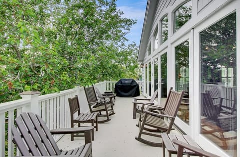 Back porch with rockers & propane grill.