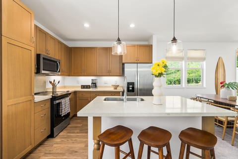 Spacious kitchen features barstool seating and updated appliances. Easily keep everyone's favorites stocked with grocery shopping just 10 minutes away.