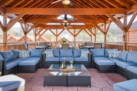 Huge covered deck with a lounge area, outdoor dining, and a BBQ grill.