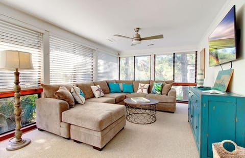 Sunroom with flat screen TV.