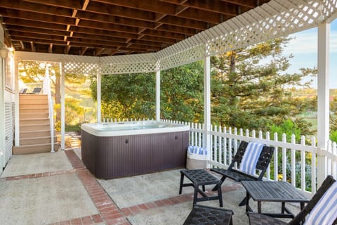 Covered section of the patio features a private hot tub.