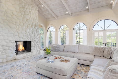 High-end interior design features arched windows and doorways.