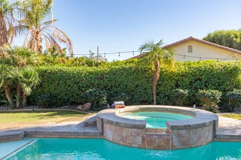 Private pool and hot tub with hedges for privacy.