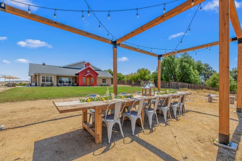 Large, open-air dining table overlooking the private soccer field.