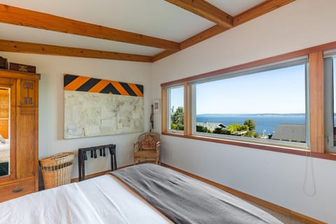 Bedroom bliss with picture-framed ocean view.