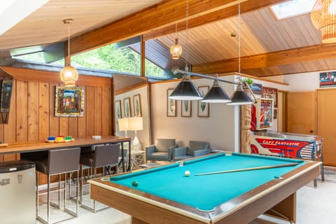 The Tiki Lounge game room features a pool table, arcade game, and more!