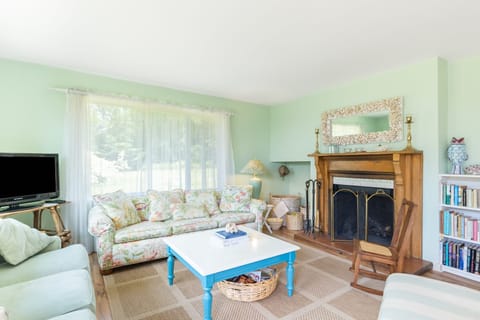 Living room features a comfortable seating and a fireplace.