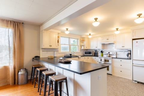 The kitchen features an island with counter-top seating.