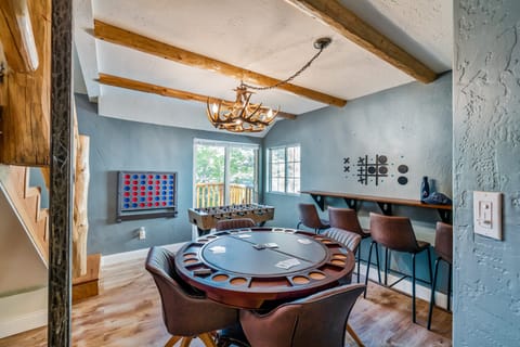 Game room with a card table and foosball.