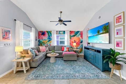 Plush sectional sofa and flat-screen TV in the living area.